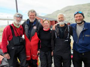 Members of the Circumnavigation of Greenland team aboard a wind-powered sled. On the left, Manuel Olivera.