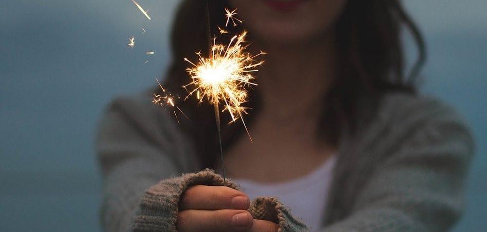 Image of a girl with a flare in her hands as a celebration