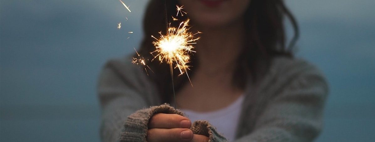 Image of a girl with a flare in her hands as a celebration