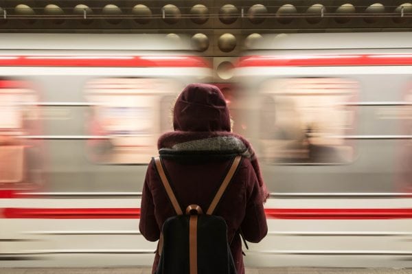  Image of a person waiting for the train to stop