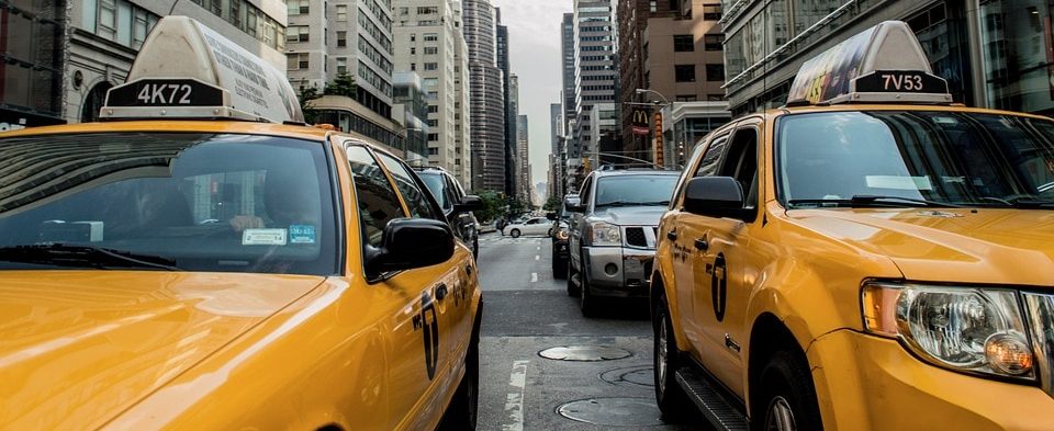 Cabs on a busy street.