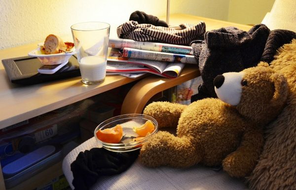 A cluttered desk and chair.