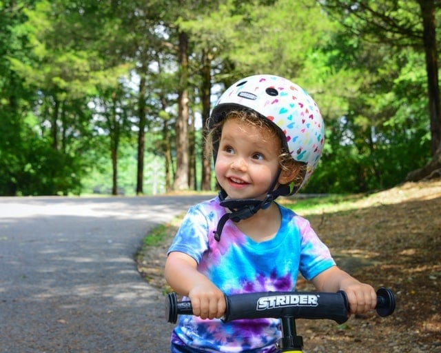 A kid riding a bicycle. 