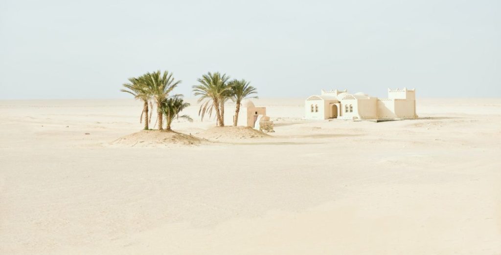 white concrete house in the desert