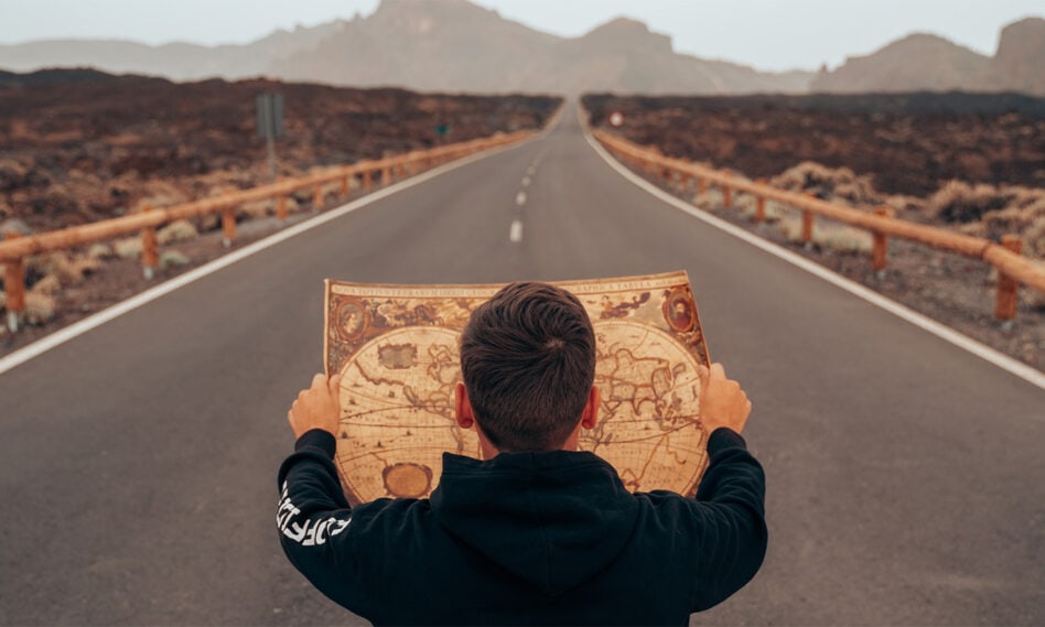 Photo of man holding a map