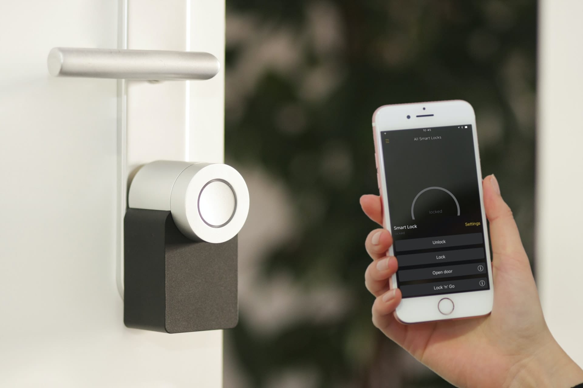 A smart lock and a person holding a smartphone next to it showing one of the ways to use artificial intelligence in homes
