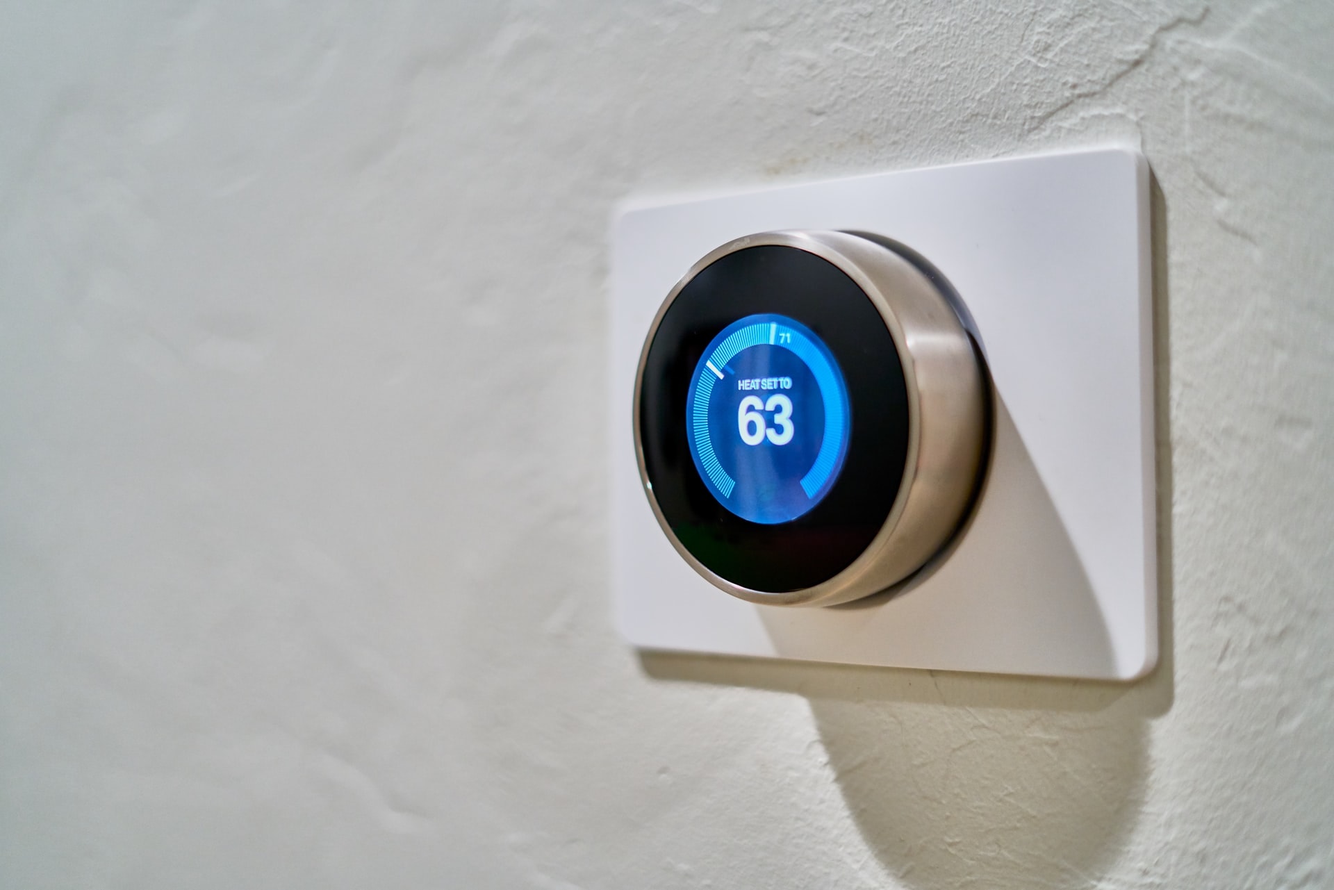 A smart thermostat on a white wall