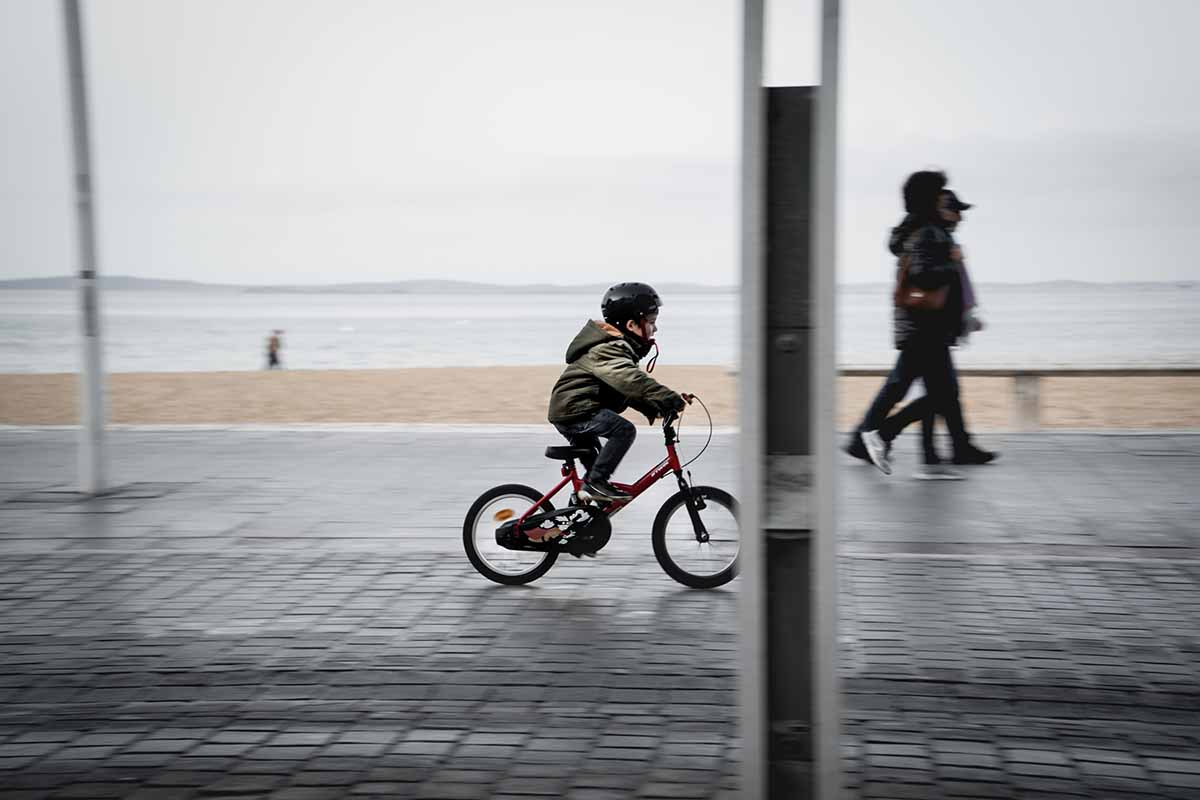 Child on a bicycle on an urban road. 