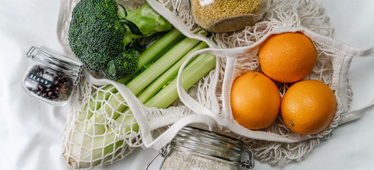 Reusable grocery bag with healthy foods inside.