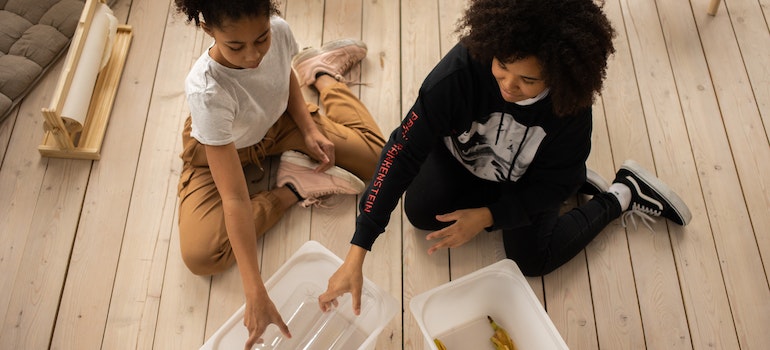 Kids separating plastic and organic items.