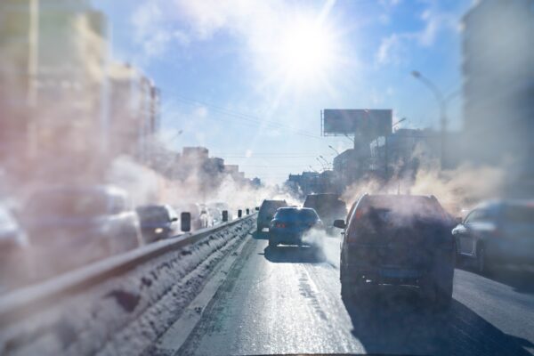 cars driving on the road and generating emissions