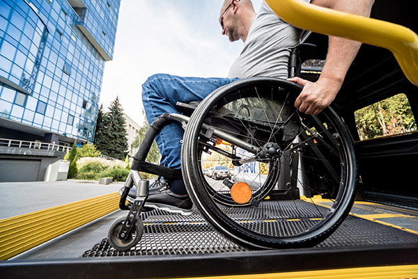 un hombre en silla de ruedas bajando del autobus