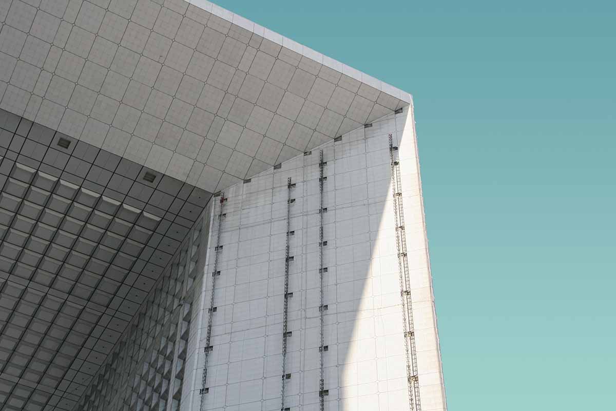 Arch of La Défense in Puteaux, France, a concrete building. 