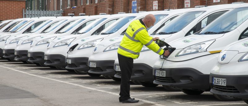 Image of an operator checking a car in an electric car parking